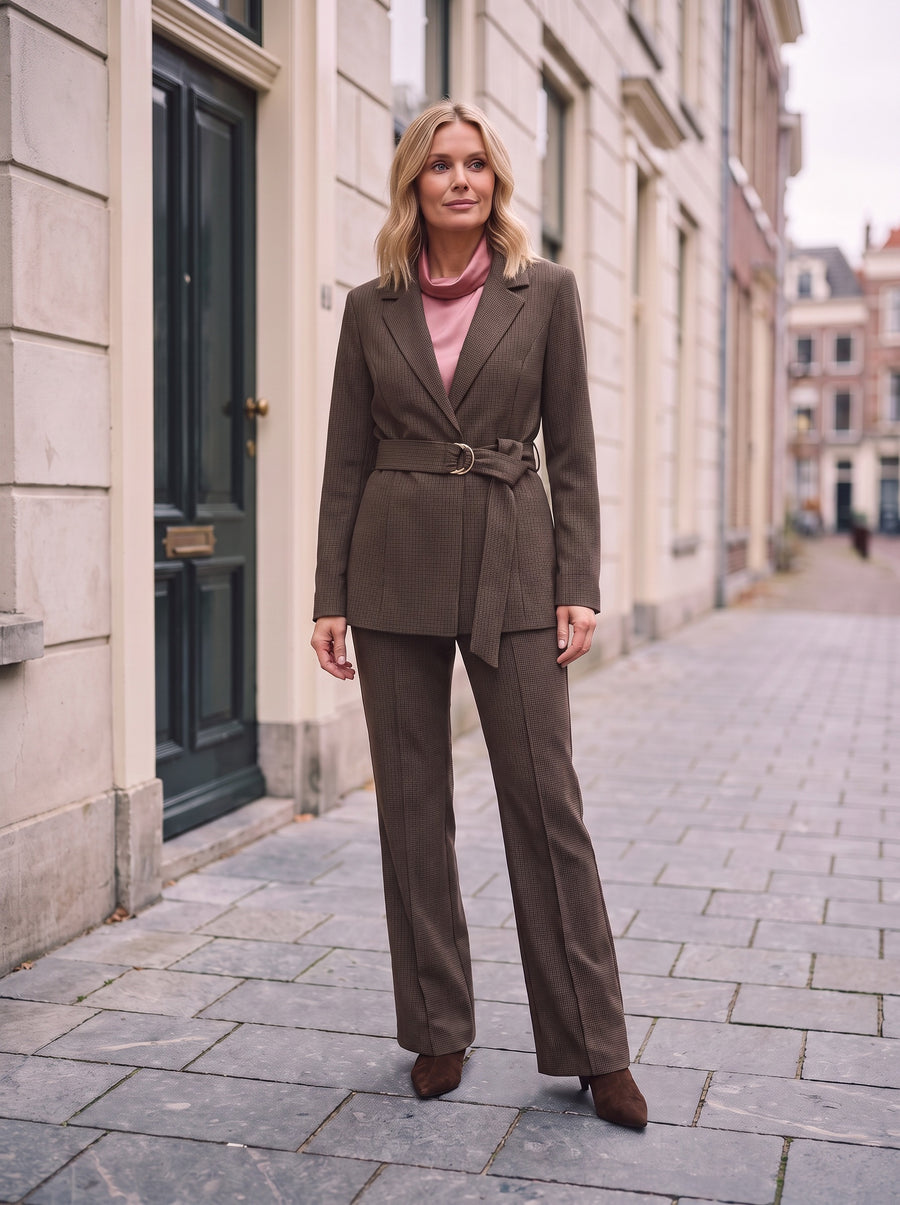 Model in bruine geruite Faya Blazer met ceintuur over een zachtroze satijnen Jada Top en bruine geruite Star Pants met bruine suede haklaarzen
